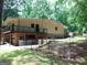 Spacious backyard features a balcony, brick elements, and a well-kept lawn at 205 Avon Dr, Fayetteville, GA 30215