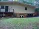 View of the backyard showing the lower level brick exterior and walkout access at 205 Avon Dr, Fayetteville, GA 30215
