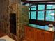 Dining area featuring a stone accent wall, built-in oven, and wooden cabinetry at 205 Avon Dr, Fayetteville, GA 30215