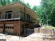 Multi-level home showcasing a spacious back balcony, garage, and brick design at 205 Avon Dr, Fayetteville, GA 30215