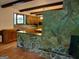 Cozy living room featuring a stone fireplace and wooden beams at 205 Avon Dr, Fayetteville, GA 30215