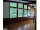 Bright living room with wood floors, a large window showcasing an outdoor view, and wood-trimmed walls at 205 Avon Dr, Fayetteville, GA 30215