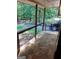 Charming porch with stone flooring, wooden beams, and a view of the lush, wooded surroundings at 205 Avon Dr, Fayetteville, GA 30215
