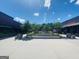 Outdoor view of Ashford Lane with trees and storefronts on a partly cloudy day at 241 Perimeter Walk, Atlanta, GA 30338