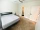 Neutral bedroom with ceiling fan features a large bed, carpet floors, and ensuite bathroom at 241 Perimeter Walk, Atlanta, GA 30338