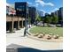 Attractive community space with outdoor seating, a grassy area, and walkways with nearby shops and restaurants at 241 Perimeter Walk, Atlanta, GA 30338