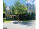 Traditional brick exterior of a multi-story home featuring a covered entryway and manicured landscaping at 241 Perimeter Walk, Atlanta, GA 30338