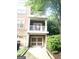 Charming townhome showcasing a two-car garage, double balconies, and manicured landscaping, offering curb appeal at 241 Perimeter Walk, Atlanta, GA 30338