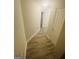 Clean hallway with wood flooring, neutral walls and white trim leading to other rooms in the house at 241 Perimeter Walk, Atlanta, GA 30338