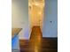 Hallway view featuring pristine hardwood floors, leading to multiple rooms with crisp white trim at 241 Perimeter Walk, Atlanta, GA 30338
