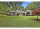 Backyard with mature trees, lush green lawn and mature plantings at 107 Jennings Yard, Peachtree City, GA 30269