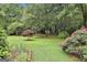 Secluded backyard featuring manicured landscaping and mature trees at 107 Jennings Yard, Peachtree City, GA 30269