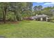 Large, private backyard with mature trees and lush lawn, ideal for outdoor entertaining and recreation at 107 Jennings Yard, Peachtree City, GA 30269