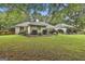 Expansive backyard featuring lush green lawn, mature trees, and meticulously maintained landscaping beds at 107 Jennings Yard, Peachtree City, GA 30269