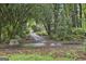Private, wooded driveway leading to a charming home, offering seclusion and natural beauty at 107 Jennings Yard, Peachtree City, GA 30269