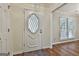 Entryway featuring hardwood floors, and glass accented front door with views of the adjacent dining space at 107 Jennings Yard, Peachtree City, GA 30269