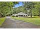 Charming single-story home featuring a quaint front porch and a well-manicured lawn with mature trees at 107 Jennings Yard, Peachtree City, GA 30269