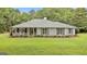 Charming single-story home featuring a well-manicured lawn and inviting front porch with American flag and brick accents at 107 Jennings Yard, Peachtree City, GA 30269