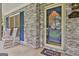Charming front porch with rocking chairs, blue shutters, and a decorative front door with stained glass at 107 Jennings Yard, Peachtree City, GA 30269