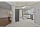 Open-concept kitchen boasts white cabinets, a kitchen island, stainless steel appliances, and seamless access to dining area at 107 Jennings Yard, Peachtree City, GA 30269