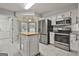 Modern kitchen featuring stainless steel appliances, a center island, white cabinetry and granite countertops at 107 Jennings Yard, Peachtree City, GA 30269