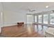 Large living room features hardwood floors, wainscoting, a ceiling fan, and access to the breakfast nook at 107 Jennings Yard, Peachtree City, GA 30269