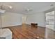 Open-concept living room showcases hardwood floors, wainscoting, neutral walls, and seamless flow into other living spaces at 107 Jennings Yard, Peachtree City, GA 30269