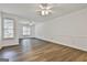 Bright living room with wood floors, ceiling fan, chair rail and large windows at 107 Jennings Yard, Peachtree City, GA 30269