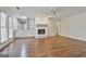 Inviting living room features hardwood floors, a fireplace, built-in shelving, and natural light at 107 Jennings Yard, Peachtree City, GA 30269