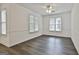 Bright living room with wood floors, ceiling fan, chair rail and large windows at 107 Jennings Yard, Peachtree City, GA 30269