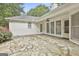 Large stone patio with exterior entrance and mature plantings at 107 Jennings Yard, Peachtree City, GA 30269