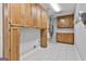 Spacious utility room with ample cabinet storage space, tile flooring, and modern utilities at 107 Jennings Yard, Peachtree City, GA 30269