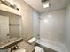 This bathroom features a granite countertop, white tile, and combination shower and tub at 604 Thomasville Blvd, Atlanta, GA 30315