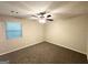 This bedroom features neutral walls, soft carpet, a window, and ceiling fan at 604 Thomasville Blvd, Atlanta, GA 30315
