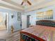 Bedroom featuring a tray ceiling and view into the bathroom at 2040 Elm Grove Ln, Hampton, GA 30228
