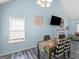 Bright dining room with vaulted ceiling and cozy view to the living area and a fireplace at 2040 Elm Grove Ln, Hampton, GA 30228