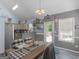 Bright dining area with bar counter to the kitchen, vaulted ceilings, modern flooring, and a rear door at 2040 Elm Grove Ln, Hampton, GA 30228