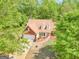 Charming brick home featuring a well-manicured front yard, attached garage, and beautifully landscaped with mature trees at 2040 Elm Grove Ln, Hampton, GA 30228