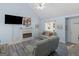 Bright living area features a cozy fireplace, contemporary flooring, and ample seating with updated fixtures at 2040 Elm Grove Ln, Hampton, GA 30228