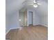 Finished attic features wood-look flooring, neutral walls, and an access door to the rest of the house at 1917 Kevin Se Dr, Conyers, GA 30013