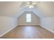 A large finished attic features wood-look floors, neutral walls, and a dormer window at 1917 Kevin Se Dr, Conyers, GA 30013