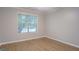 Bright bedroom with wood-look flooring, a window with natural light, and neutral walls at 1917 Kevin Se Dr, Conyers, GA 30013