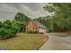 Traditional brick home with attached garage, a well-kept lawn, and plenty of parking at 1917 Kevin Se Dr, Conyers, GA 30013