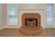 Cozy brick fireplace featuring a white mantle and hearth, next to a window with natural light at 1917 Kevin Se Dr, Conyers, GA 30013
