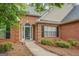 Inviting front entrance with brick facade, a pathway and well maintained landscaping at 1917 Kevin Se Dr, Conyers, GA 30013