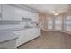Bright kitchen features white cabinets, granite countertops, and stainless steel dishwasher at 1917 Kevin Se Dr, Conyers, GA 30013