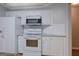 Modern kitchen with white cabinets, granite countertops, and stainless steel microwave at 1917 Kevin Se Dr, Conyers, GA 30013