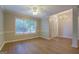Open-concept living room with hardwood floors, large window, and modern trim at 1917 Kevin Se Dr, Conyers, GA 30013