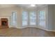 Cozy living room area with a brick fireplace and large windows offering serene outdoor views at 1917 Kevin Se Dr, Conyers, GA 30013