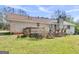 Exterior view of a brick home with a spacious backyard and multiple deck areas at 1001 Stagecoach Rd, Stockbridge, GA 30281